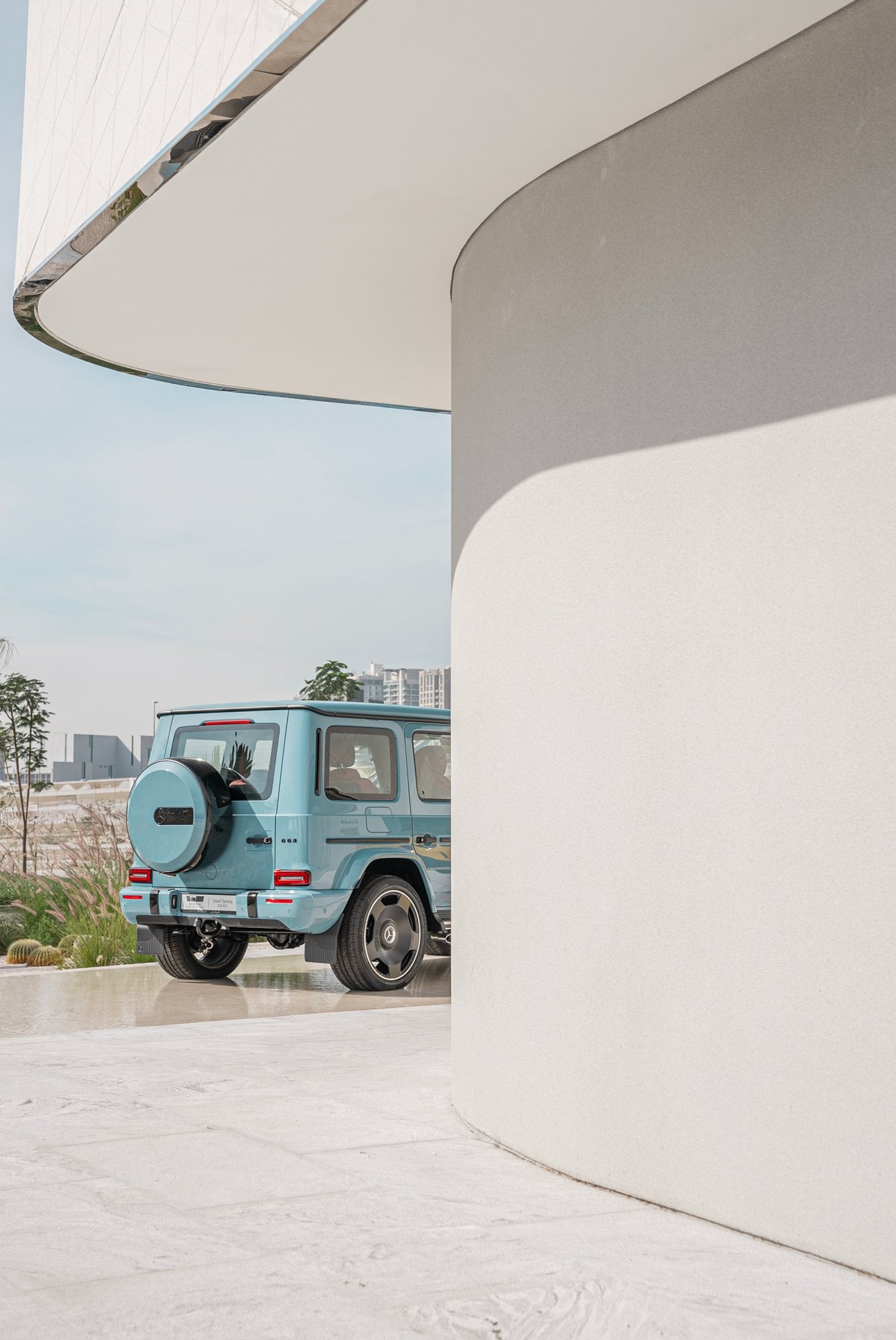 Geländewagen neben skulpturaler weißer Architektur