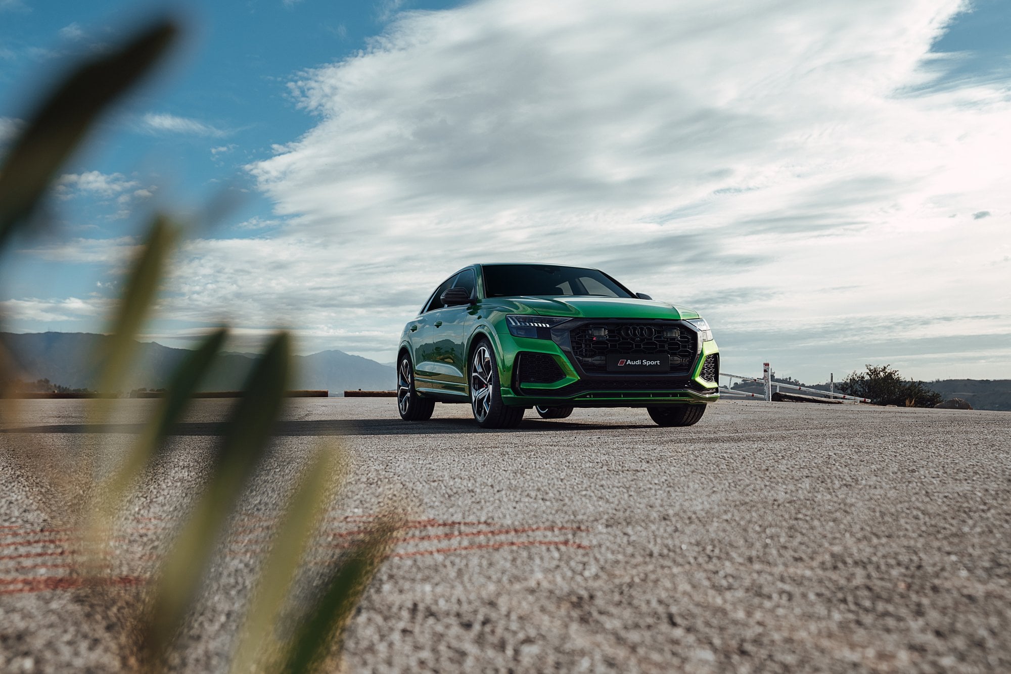 Grüner Audi an einem Aussichtspunkt unter weitem Himmel